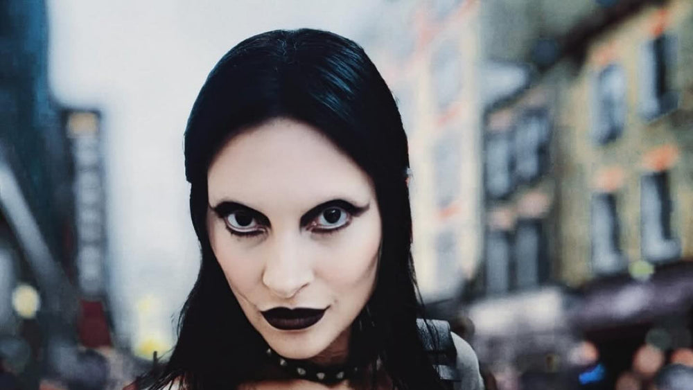 Person wearing a black and red graphic t-shirt on a city street