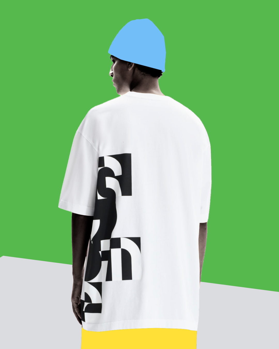 Person wearing a white t-shirt with black text on a green background